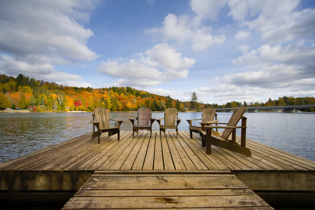 chairs on a wooden deck on the lake