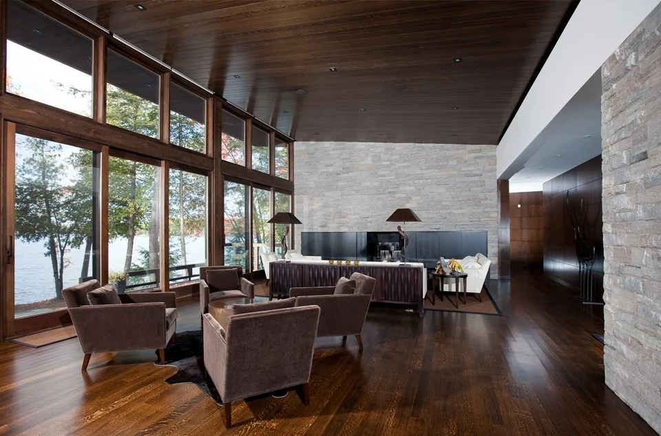 contemporary living room with lake view through landscape windows