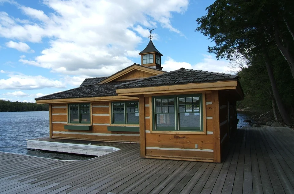 wooden boat house on the lake with wooden pier