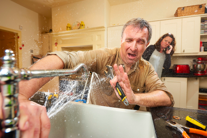 A husband tries (and fails) to fix a kitchen sink himself, while his wife looks on. Meanwhile, she's calling in a professional.