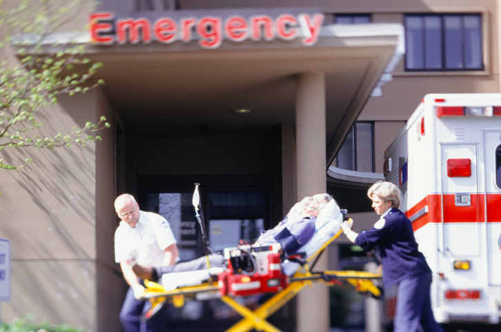 Paramedics wheel an injured construction worker into a hospital emergency room.